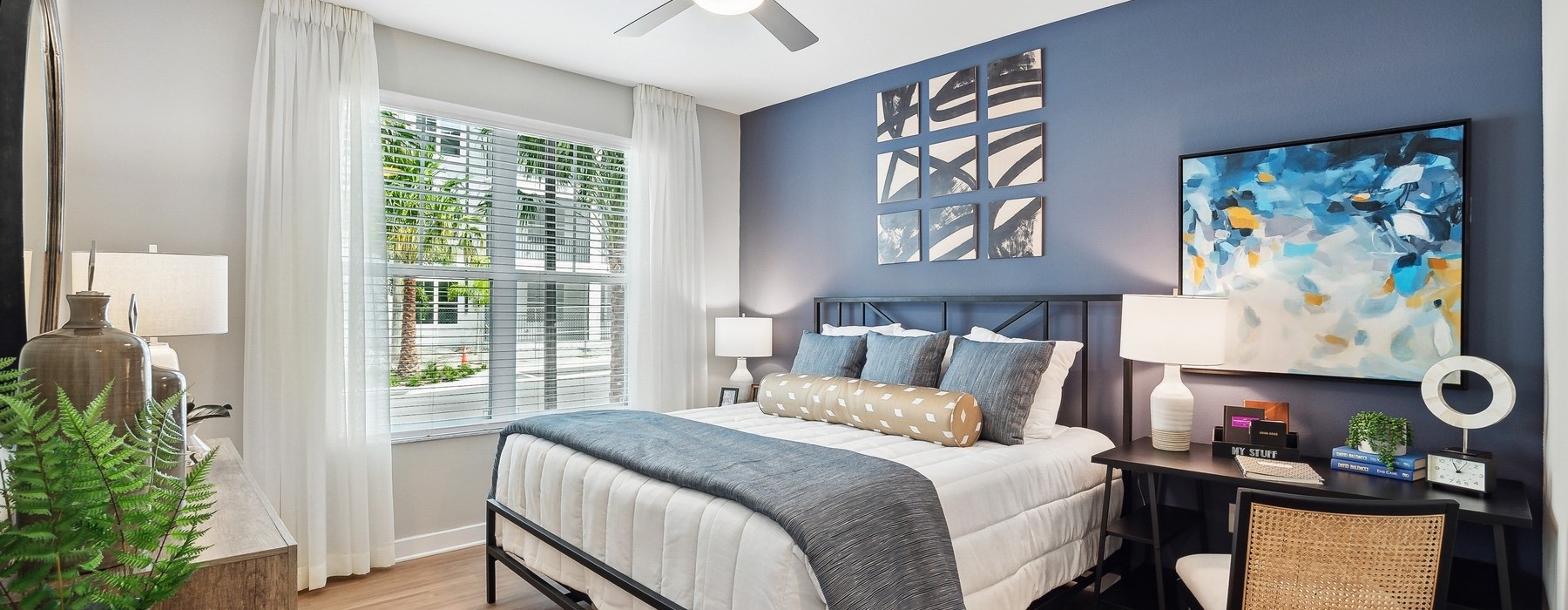 large bedroom with ceiling fan and light fixture at Bainbridge Mission Pointe in Orlando, FL