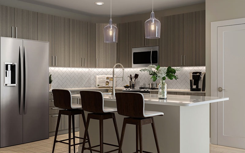 pendant lighting over kitchen island with bar stools
